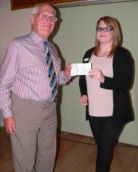 Rtn. John Orbell presenting a donation of Â£50 to Charlotte Darlow